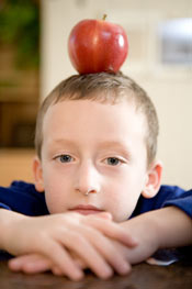 boy balancing apple on head